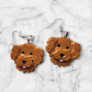 Handmade ruby groodle earrings featuring adorable curly-haired dog faces in rich ruby tones, crafted from lightweight, high-quality materials.